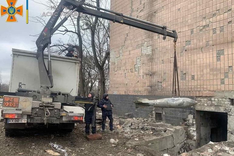 Sappers of the State Emergency Service of Ukraine remove non exploded aviation bomb FAB-500, amid the Russian invasion of Ukraine, in Kharkiv, Ukraine, in this handout picture released March 4, 2022. Press service of the State Emergency Service of Ukraine/Handout via REUTERS ATTENTION EDITORS - THIS IMAGE HAS BEEN SUPPLIED BY A THIRD PARTY.