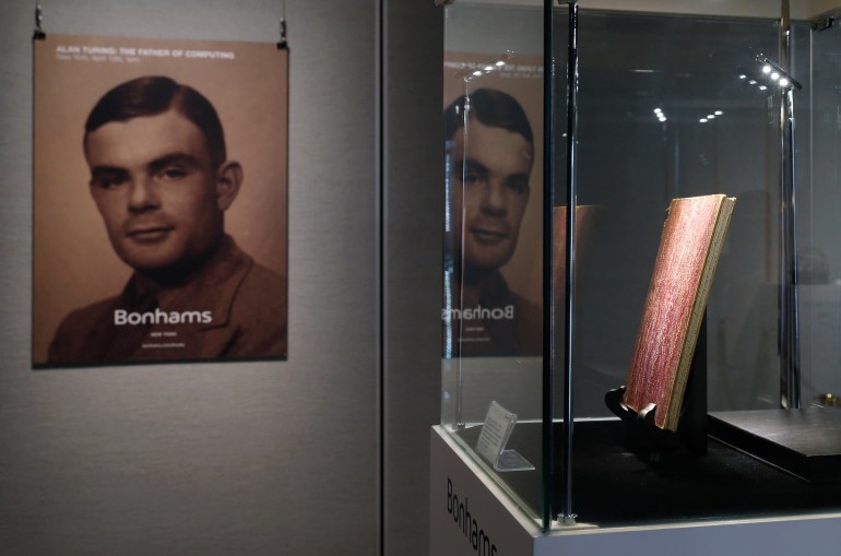 FILE - In this Thursday, March 19, 2015 file photo, a notebook of British mathematician and pioneer in computer science Alan Turing, the World War II code-breaking genius, is displayed in front of his portrait during an auction preview in Hong Kong. Britain's government will posthumously pardon thousands of gay and bisexual men convicted under long-repealed anti-gay laws. The calls for a more sweeping action came after World War II codebreaker Alan Turing was awarded a posthumous royal pardon in 2013 after a conviction of indecency in 1952. The gay computer science pioneer was stripped of his security clearance and later committed suicide. (AP Photo/Kin Cheung, File)