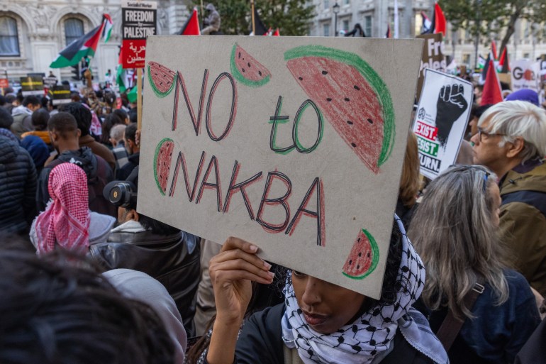 A pro-Palestinian demonstrator holds a sign reading 'No to Nakba' during a rally outside Downing Street in support of the Palestinian population of Gaza on 14th October 2023 in London, United Kingdom. The watermelon, in the colours of the Palestinian flag, is a symbol of resistance in occupied Palestine. Large Palestinian solidarity rallies have been held throughout the UK following Israel's retaliatory attacks on Gaza despite a warning from UK Home Secretary Suella Braverman that waving Palestinian flags or chanting popular slogans in support of Palestine may constitute public order offences. (photo by Mark Kerrison/In Pictures via Getty Images)