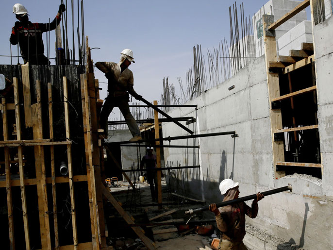 JERUSALEM, -, - : Palestinian laborers work on a construction site in Ramat Shlomo, a Jewish settlement in the mainly Palestinian eastern sector of Jerusalem, on October 30, 2013. Israel freed 26 veteran Palestinian prisoners overnight in line with commitments to the US-backed peace process, but moved in tandem to ramp up settlement in annexed east Jerusalem. AFP PHOTO/GALI TIBBON