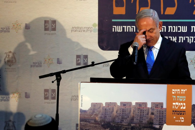 Israeli Prime Minister Benjamin Netanyahu gestures as he speaks during an event inaugurating a new neighborhood in Kiryat Arba, a Jewish settlement in Hebron in the Israeli-occupied West Bank
