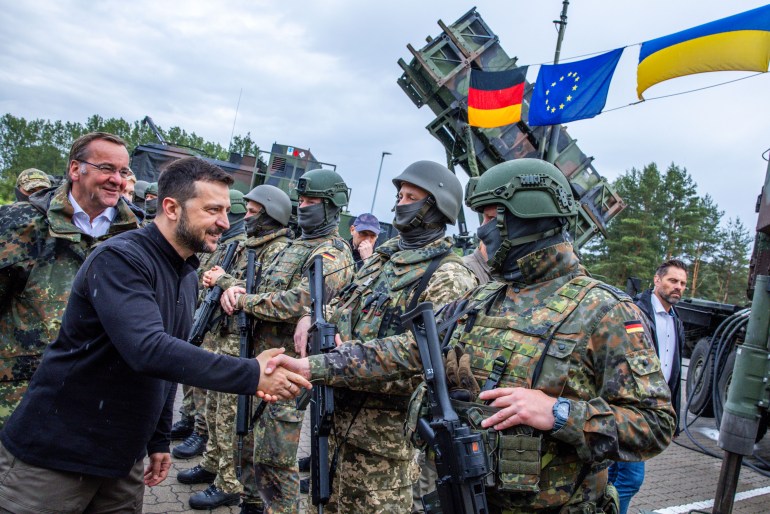 MECKLENBURG, GERMANY - JUNE 11: Volodymyr Zelensky, President of Ukraine, (2L) and Boris Pistorius, (L) Federal Minister of Defense are seen visiting the training of Ukrainian soldiers on the Patriot anti-aircraft missile system at a military training ground on June 11, 2024 in Mecklenburg, Germany. The international reconstruction conference for Ukraine will take place on 11 and 12 June Zelensky is in Berlin to also attend the Ukrainian Recovery Conference. Germany is the second biggest donor of military aid to Ukraine. (Photo by Jens Büttner - Pool/Getty Images)