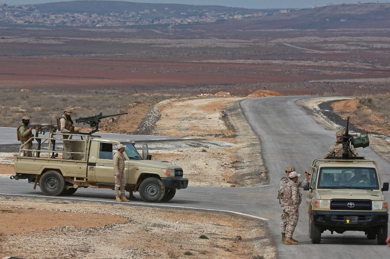 A picture taken during a tour origanized by the Jordanian Army shows soldiers patrolling along the border with Syria to prevent trafficking, on February 17, 2022. Drug trafficking from Syria into Jordan is becoming "organised" with smugglers stepping up operations and using sophisticated equipment including drones, Jordan's army said, warning of a shoot-to-kill policy. Since the beginning of this year, Jordan's army has killed 30 smugglers and foiled attempts to smuggle into the kingdom from Syria 16 million Captagon pills -- more than they seized in the whole of 2021 -- the military said. (Photo by Khalil MAZRAAWI / AFP)