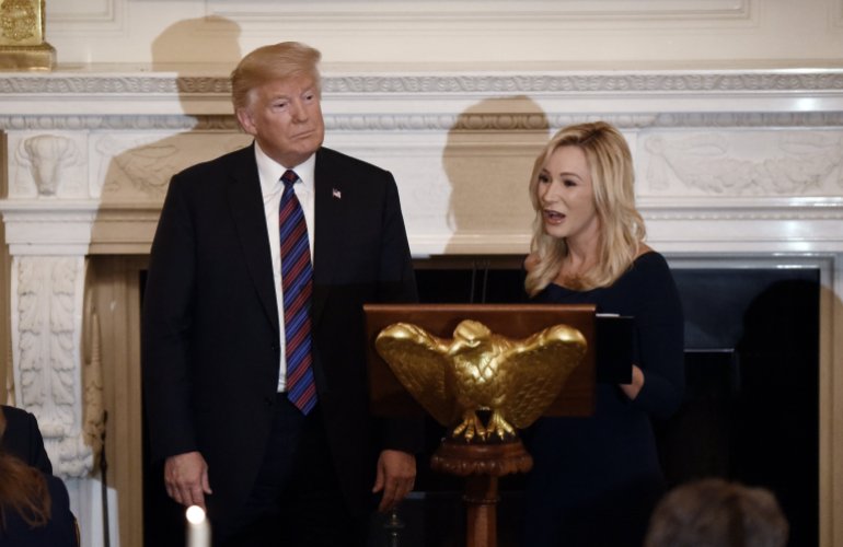 U.S. President Donald Trump listens to Evangelist and Pastor, Paula White during a dinner for Evangelical leadership in the State Dining Room of the White House August 27, 2018 in Washington, DC, USA.