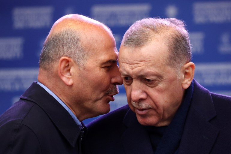 Turkish President Tayyip Erdogan listens to Turkish Interior Minister Suleyman Soylu during a rally ahead of the May 14 presidential and parliamentary elections, in Istanbul, Turkey May 12, 2023. REUTERS/Hannah McKay