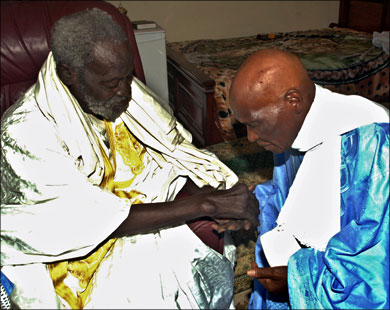 afp : (FILES) A picture taken 01 March 2001 shows Senegalese President Abdoulaye Wade (R) consulting his marabout (spiritual guide), Serigne Saliou Mbacke in Touba,