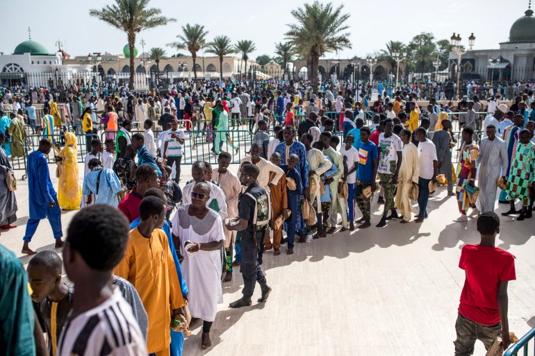 Pilgrims of the Mouride Brotherhood ait in lines to enter the Grand Mosque during the Grand Magal of Mourides' annual muslim pilgrimage in Touba on September 15, 2022. (Photo by MUHAMADOU BITTAYE / AFP) (Photo by MUHAMADOU BITTAYE/AFP via Getty Images)