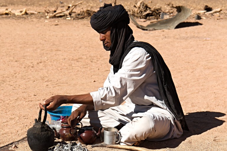 View of the village of Touareg people near Djanet town. Touareg man making tea. Tassili n'Ajjer National Park. Sahara desert, Algeria. 17th November 2023.; Shutterstock ID 2407110677; purchase_order: AJA; job: ; client: ; other: