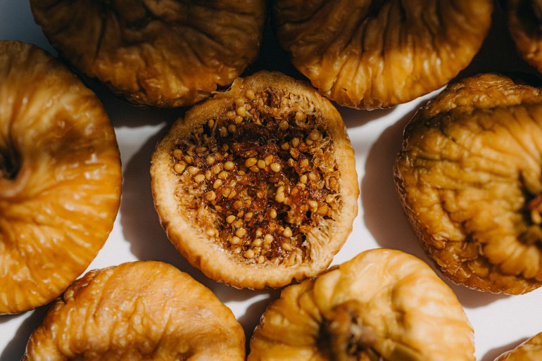 Dried Figs on White Surface - stock photo