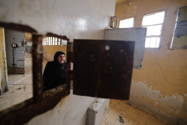 Ibtissam Al-Nadaf who said she is still mourning two sons, one killed by a sniper during the siege of Al-Assali, the other disappeared into Sednaya prison in 2018, reacts as she hopes for any sign of her son as she tours for first time the Sednaya prison, which was known as a slaughterhouse under Syria's Bashar al-Assad rule, after fighters of the ruling Syrian body ousted Bashar al-Assad, in Sednaya, Syria December 24, 2024. REUTERS/Zohra Bensemra