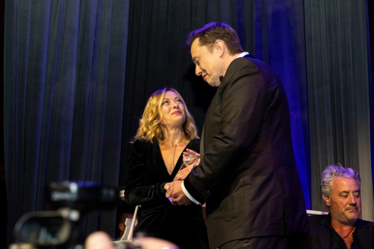 Elon Musk, CEO of Tesla, right, presents Giorgia Meloni, Italy's president of the Council of Ministers, with an award during the Global Citizen Awards dinner, Monday, Sept. 23, 2024, in New York. (AP Photo/Michelle Farsi)