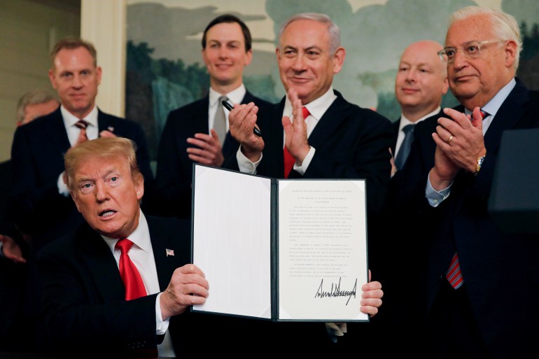 U.S. President Donald Trump holds a proclamation recognizing Israel's sovereignty over the Golan Heights as he is applauded by Israel's Prime Minister Benjamin Netanyahu and others during a ceremony in the Diplomatic Reception Room at the White House in Washington, U.S., March 25, 2019. REUTERS/Carlos Barria TPX IMAGES OF THE DAY