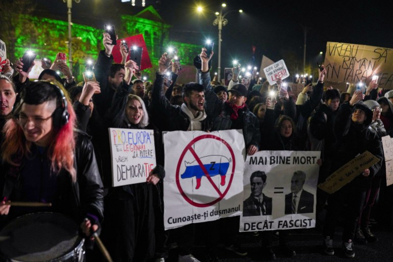 People chant slogans during a protest against Calin Georgescu, the independent candidate for Romanian presidency who made it to runoff, in Bucharest, Romania, November 27, 2024. REUTERS/Andreea Campeanu