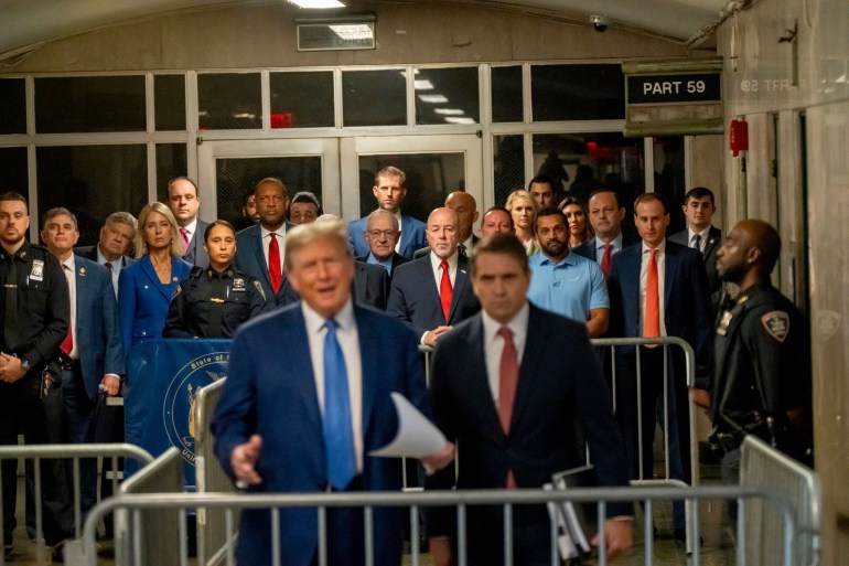 Former President Donald Trump's Hush Money Trial Continues In New York NEW YORK, NEW YORK - MAY 20: Former NYC police commissioner Bernie Kerik, attorney Alan Dershowitz, Eric Trump, Kash Patel and other supporters listen as former U.S. President Donald Trump speaks to the media during his trial for allegedly covering up hush money payments at Manhattan Criminal Court on May 20, 2024 in New York City. Trump was charged with 34 counts of falsifying business records last year, which prosecutors say was an effort to hide a potential sex scandal, both before and after the 2016 presidential election. Trump is the first former U.S. president to face trial on criminal charges. (Photo by Mark Peterson-Pool/Getty Images)