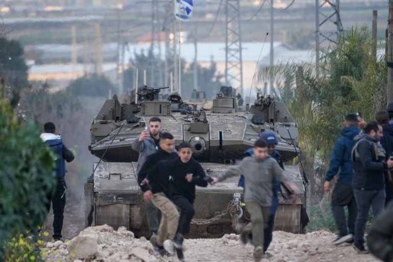 جنين - الضفة الغربية Israeli soldiers drive a tank towards the occupied West Bank of Jenin camp, during an ongoing army operation, Feb. 23, 2025. (AP Photo/Majdi Mohammed)