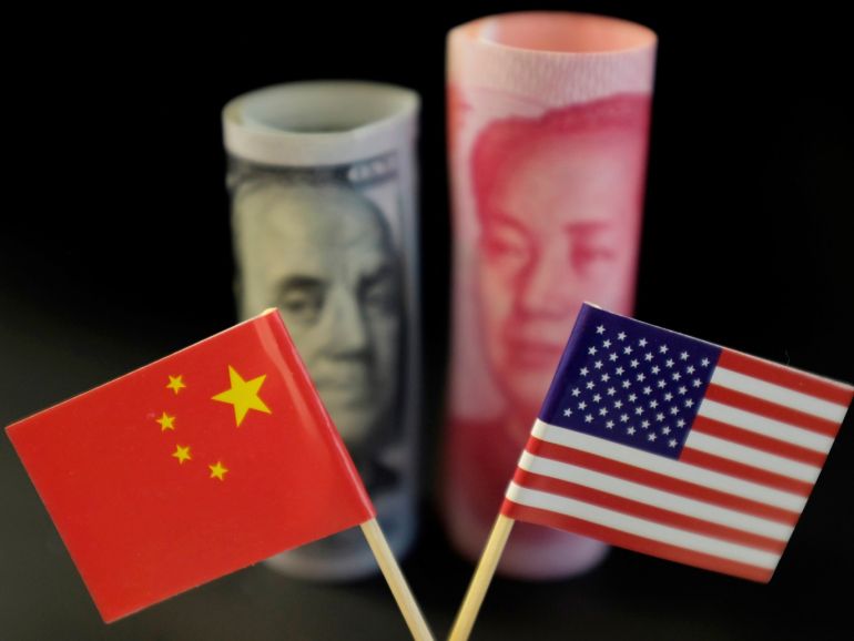 U.S. and Chinese flags are seen in front of a U.S. dollar banknote featuring American founding father Benjamin Franklin and a China's yuan banknote featuring late Chinese chairman Mao Zedong in this illustration picture taken May 20, 2019. Picture taken May 20, 2019. REUTERS/Jason Lee/Illustration