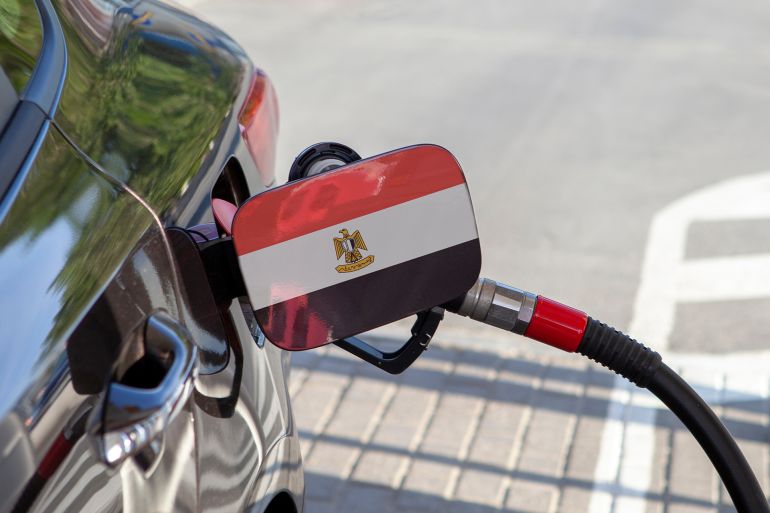 Flag of Egypte on the car's fuel tank filler flap. Fueling car with petrol pump at a gas station. Petrol station. Gasoline and oil products. Close up.; Shutterstock ID 1154884765; purchase_order: aj; job: ; client: ; other: