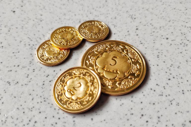 Gold coin (dinar) made from 916 gold (22 karat).; Shutterstock ID 1860917548; purchase_order: aj; job: ; client: ; other: