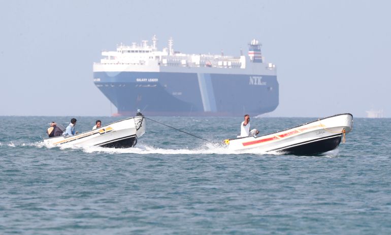 epa11012836 Boats sail past the Galaxy Leader cargo ship, seized by the Houthis offshore of the Al-Salif port on the Red Sea in the province of Hodeidah, Yemen, 05 December 2023. The Galaxy Leader ship, reportedly linked to an Israeli businessman, was seized and re-routed to offshore of the Yemeni port of Al-Salif by the Houthis on 19 November 2023 in retaliation for Israel's airstrikes on the Gaza Strip, according to statements by the Houthis. The ship, carrying around 25 crew members belonging to various nations, was seized as it was on its way to India. The Houthis, who control most of Yemen 's Red Sea coast, have fired missiles and drones at Israel and attacked more vessels transiting the area. Thousands of Israelis and Palestinians have died since the militant group Hamas launched an unprecedented attack on Israel from the Gaza Strip on 07 October, and the Israeli strikes on the Palestinian enclave which followed it. EPA-EFE/YAHYA ARHAB