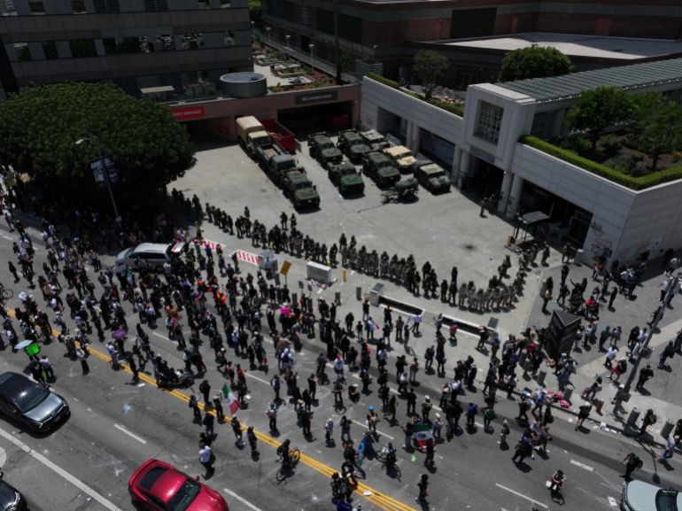 LOS ANGELES, CALIFORNIA - JUNE 8: ICE officers and national guards confront with protesters outside of the Metropolitan Detention Center in Los Angeles, California on June 8, 2025 amid protests over immigration raids. (Photo by Tayfun Coskun/Anadolu via Getty Images)