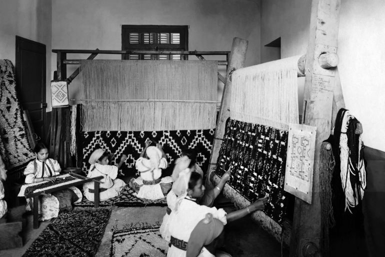 A picture taken in the 1930's shows Moroccan young weavers working in a textile workshop in Morocco, which then was a French protectorate. (Photo by AFP) (Photo by /AFP via Getty Images)