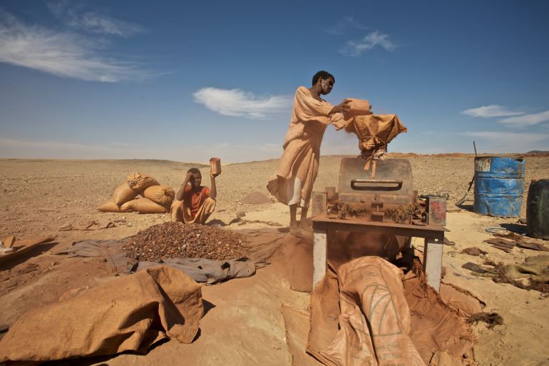 Gold prospectors grind rock spoil before washout contained therein gold, North Sudan, IV Cataract Nile region. 12 January 2007