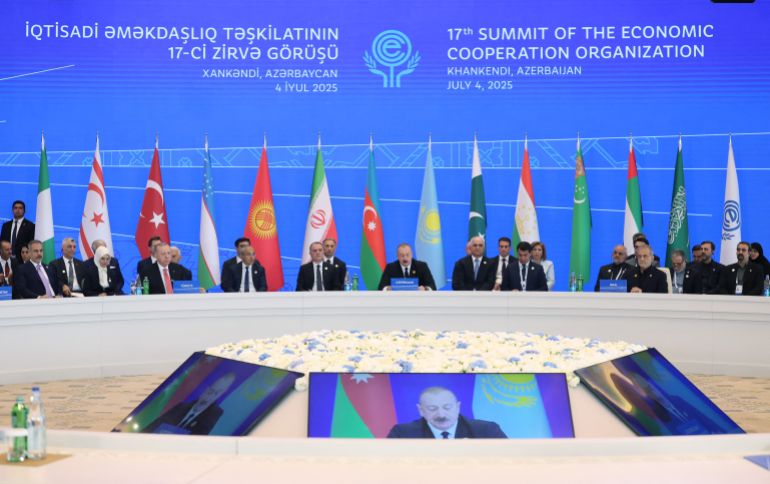 This handout photograph taken and released by the Turkish presidential press service on July 4, 2025, shows attendees, including Turkish President Recep Tayyip Erdogan, Azerbaijani President Ilham Aliyev and Iranian President Masoud Pezeshkian, taking part in the 17th Summit of the Economic Cooperation Organization in Khankendi, Azerbaijan.