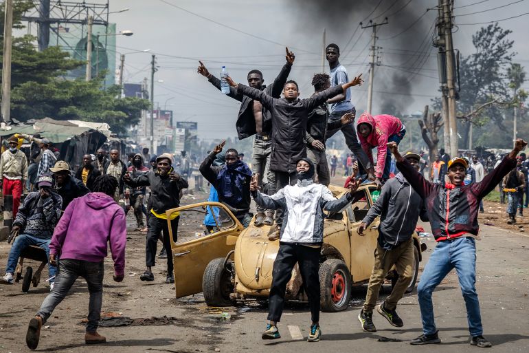 Protesters chant anti-government slogans atop a vandalised car used as a barricade to block a road during Saba Saba Day demonstrations in Nairobi on July 7, 2025. Kenya marked its fight for democracy on July 7, 2025 with police blocking main roads in Nairobi ahead of potential protests, after last month's demonstrations descended into violent clashes. Saba Saba Day marks the uprising on July 7, 1990 when Kenyans demanded a return to multi-party democracy after years of autocratic rule by then-president Daniel arap Moi. (Photo by Luis TATO / AFP)